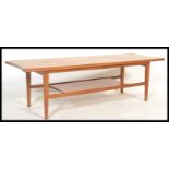 A mid century Danish influence teak wood long john coffee - occasional table being raised on