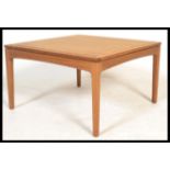 A vintage retro 20th Century teak wood coffee table by Legate raised on square tapering legs. Makers