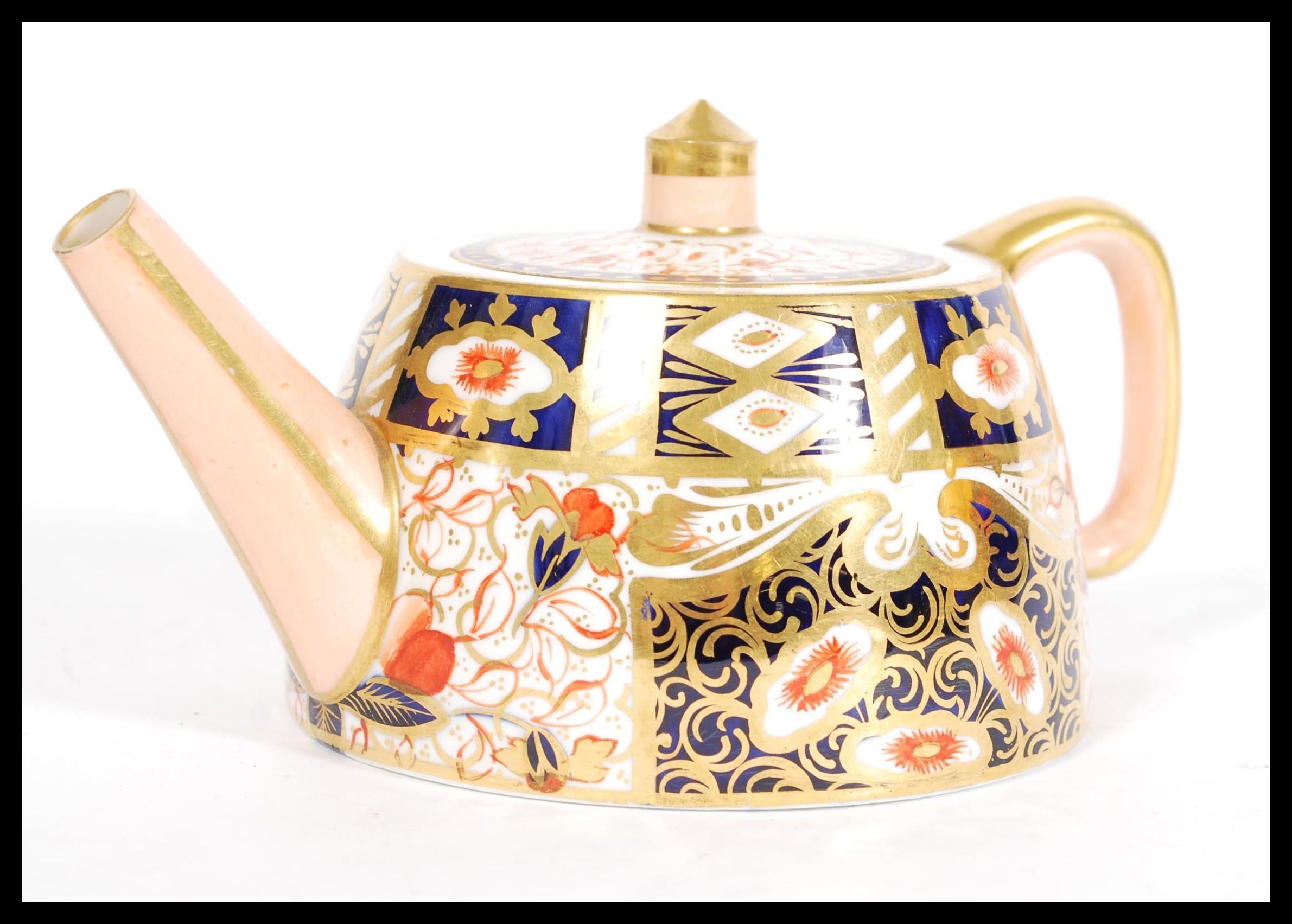 A 19th century Victorian Davenport China Imari pattern teapot of angular form being marked to the