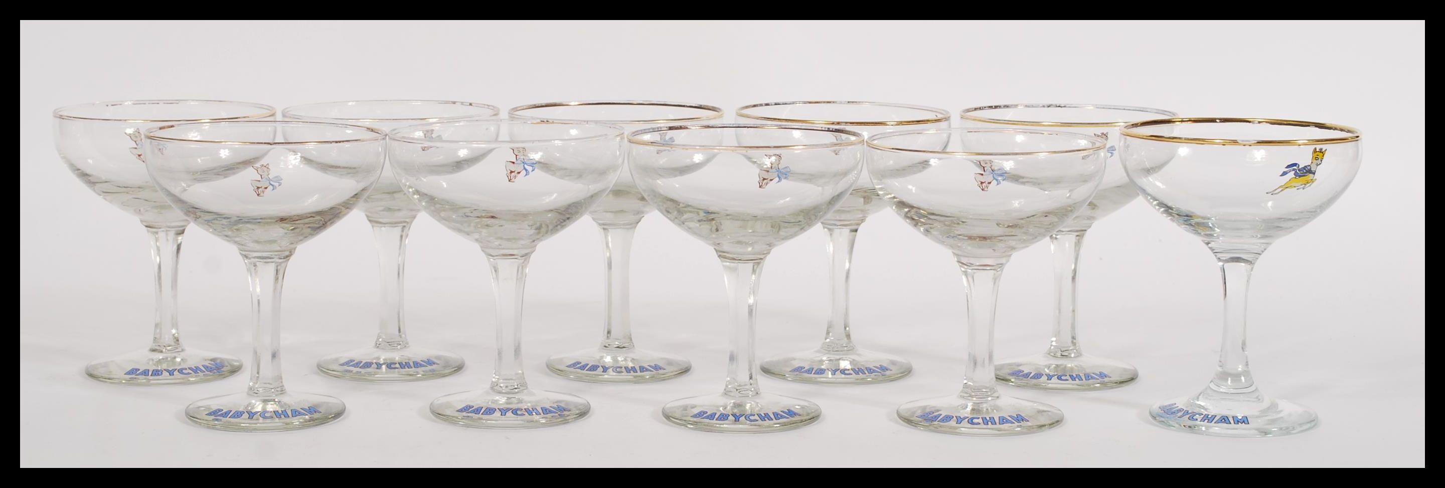 A set of ten vintage retro 20th Century Babycham glasses raised on circular bases with gilt rim