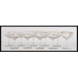 A set of ten vintage retro 20th Century Babycham glasses raised on circular bases with gilt rim