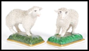 A pair of 19th Century Victorian Staffordshire miniature sheep / lamb figurines raised on plinth