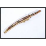 A 20th Century Chinese miniature sword / paper knife in a wooden and brass sheath with floral