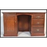 A 1920's large mahogany twin pedestal desk with a bank of drawers to one pedestal, locker cupboard