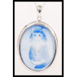 A sterling silver necklace and pendant having a ceramic cameo plaque depicting a Persian cat.