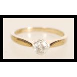 A hallmarked 9ct gold single stone solitaire ring having a central diamond of approx 30pts. Weighs