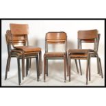 A collection of vintage retro 20th Century stacking chairs of tubular form having wooden panel seats