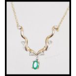 A hallmarked 9ct gold necklace having a fine rope twist chain with central faceted green stone and