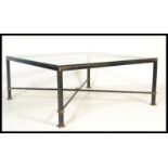 A vintage retro 20th Century cast metal coffee table of large square form having a large glass top