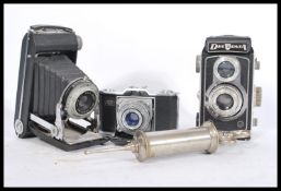A selection of three vintage cameras to include a Kodak Dakon Shutter bellows camera, a Zeiss Ikon