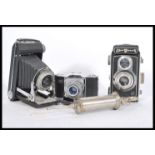 A selection of three vintage cameras to include a Kodak Dakon Shutter bellows camera, a Zeiss Ikon