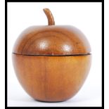A 20th wooden tea caddy in the form of an apple having a lead lined interior. Measures 11cm high