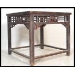 A 19th Century Qing Dynasty period Chinese square hardwood centre table, the fretted and carved