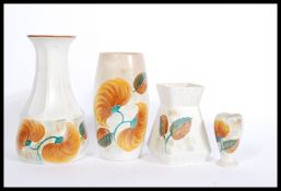 A collection of E Radford 1930's Art Deco ceramics in ' Wood's ' pattern. To include a tall vase,