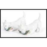 A pair of Royal Copenhagen ceramic dog figurines depicting west highland terrier and slipper model