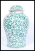 A 20th century large Chinese vase and cover having famille verte decoration with scrolled borders