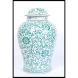 A 20th century large Chinese vase and cover having famille verte decoration with scrolled borders