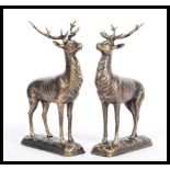 A pair of 20th century bronze effect cast iron statues / figures of deer. Standing, with antlers