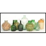 A collection of vintage 20th century acid glass carboys - bottles of large form some filled with