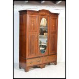A large  Edwardian mahogany decorated ( inlaid )  double wardrobe being raised on a plinth base with