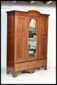 A large  Edwardian mahogany decorated ( inlaid )  double wardrobe being raised on a plinth base with