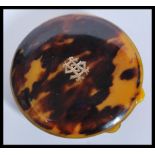 A vintage 20th century faux tortoiseshell compact