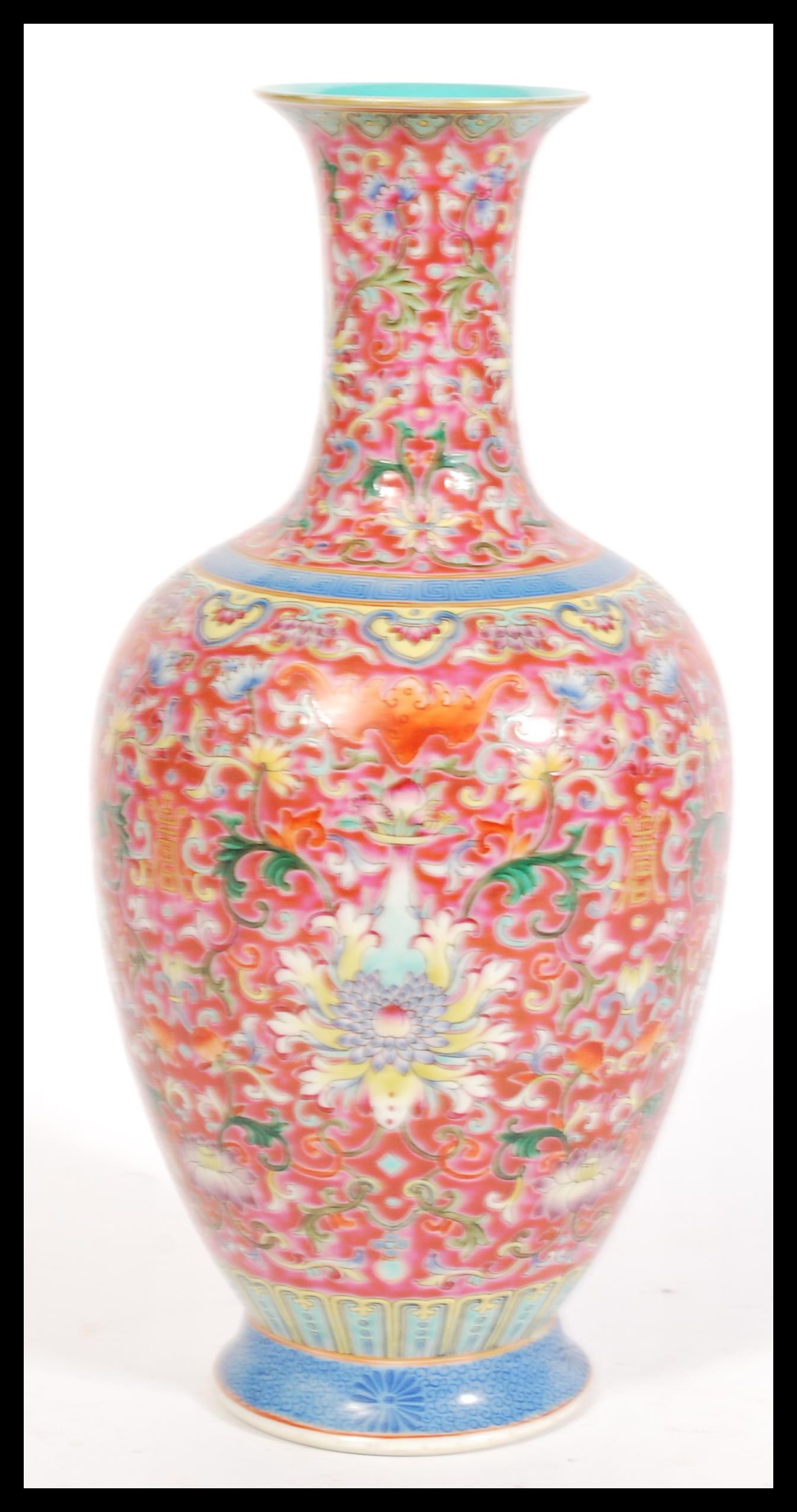 A Chinese Qianlong mark porcelain vase having fine enamel detailing on red ground. Hand decorated