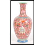 A Chinese Qianlong mark porcelain vase having fine enamel detailing on red ground. Hand decorated