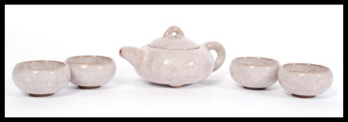 A good quality Chinese pottery Yixing teapot having a purple quartz glaze. Along with a matching set