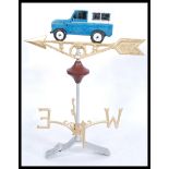 A large cast iron weather vane, with a Land Rover motif to top over the four points of the