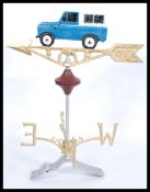 A large cast iron weather vane, with a Land Rover motif to top over the four points of the