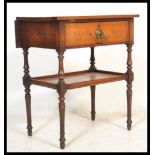 A Victorian mahogany side / lamp table being raised on turned legs with lower tier under single