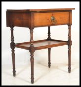 A Victorian mahogany side / lamp table being raised on turned legs with lower tier under single