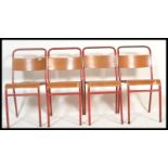 A set of 4 Remploy vintage mid 20th century church / village hall stacking chairs. With red