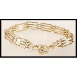 A hallmarked 9ct gold heart lock bracelet with a safety chain. Hallmarked London. Total weight 6.