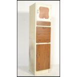A mid century retro vintage two tone upright kitchen pedestal cabinet. The white body with faux wood