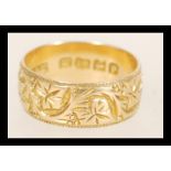 A 19th Century Victorian hallmarked 18ct gold band ring with floral engraving. Hallmarked Birmingham