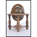 A vintage 20th Century desk globe antique style desk globe raised on a stained wood gimbal stand