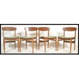 A set of four vintage retro 20th Century Remploy beech dining chairs raised on beech supports with