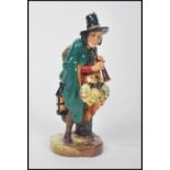 A Royal Doulton figure entitled  ' The Mask Seller