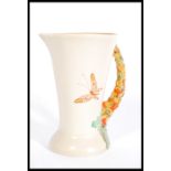 An early 20th century Clarice Cliff vase jug with crocus handle and butterfly decoration bearing