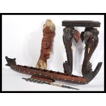 A 20th Century African tribal carved hardwood  puzzle table together with a carved hardwood