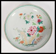 A believed 17th Century Chinese porcelain charger plate having hand painted enamel decoration of