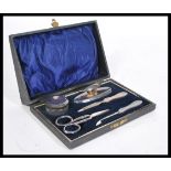A silver hallmarked cased ladies vanity set comprising scissors, button hook, rouge pot, powder puff