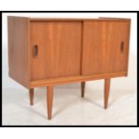 A mid century retro Danish influence teak wood pedestal record cabinet - sideboard being raised on