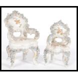A pair of 19th Century Victorian miniature ceramic Louis VXII style chairs having floral encrusted
