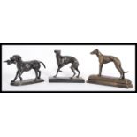 A collection of 3x cast iron bronze effect figures of dogs. Including one of hunting form, all on