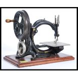 A rare 19th Century Victorian Wilcox & Gibbs sewing machine being set to a mahogany plinth, the