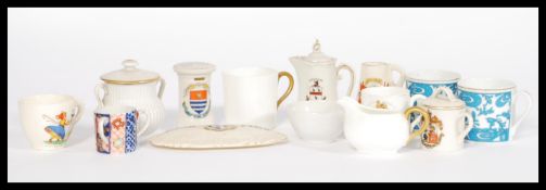 A collection of Goss souvenir ware ceramics to include teapot, mugs, post-box, coffee cans etc along