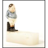 A Royal Doulton figurine pipe holder having a figu